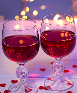 two glasses of red wine on a table
