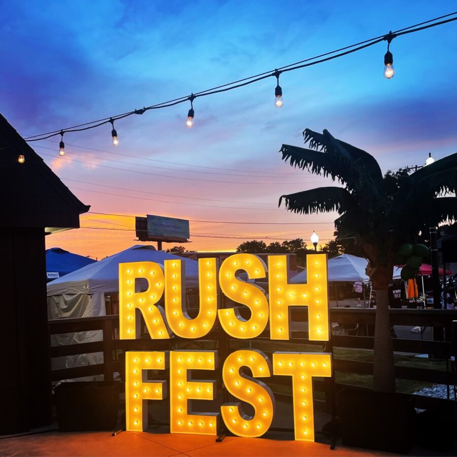 a sign that says rush fest lit up at night